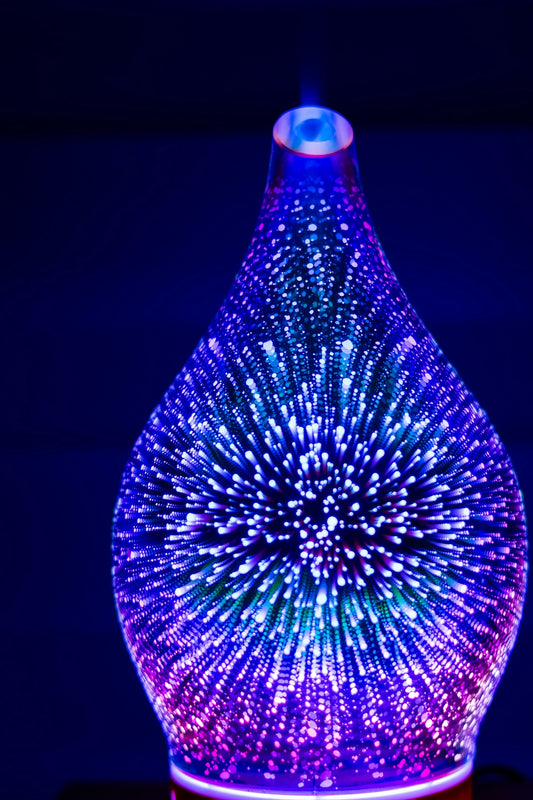 A glowing glass diffuser with colorful lights