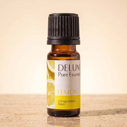 Delune Citron – ren æterisk olie, 10 ml ravfarvet glasflaske på varm travertin