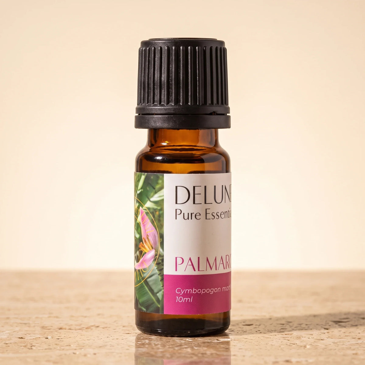Delune Palmarosa – ren æterisk olie, 10 ml ravfarvet glasflaske på varm travertin