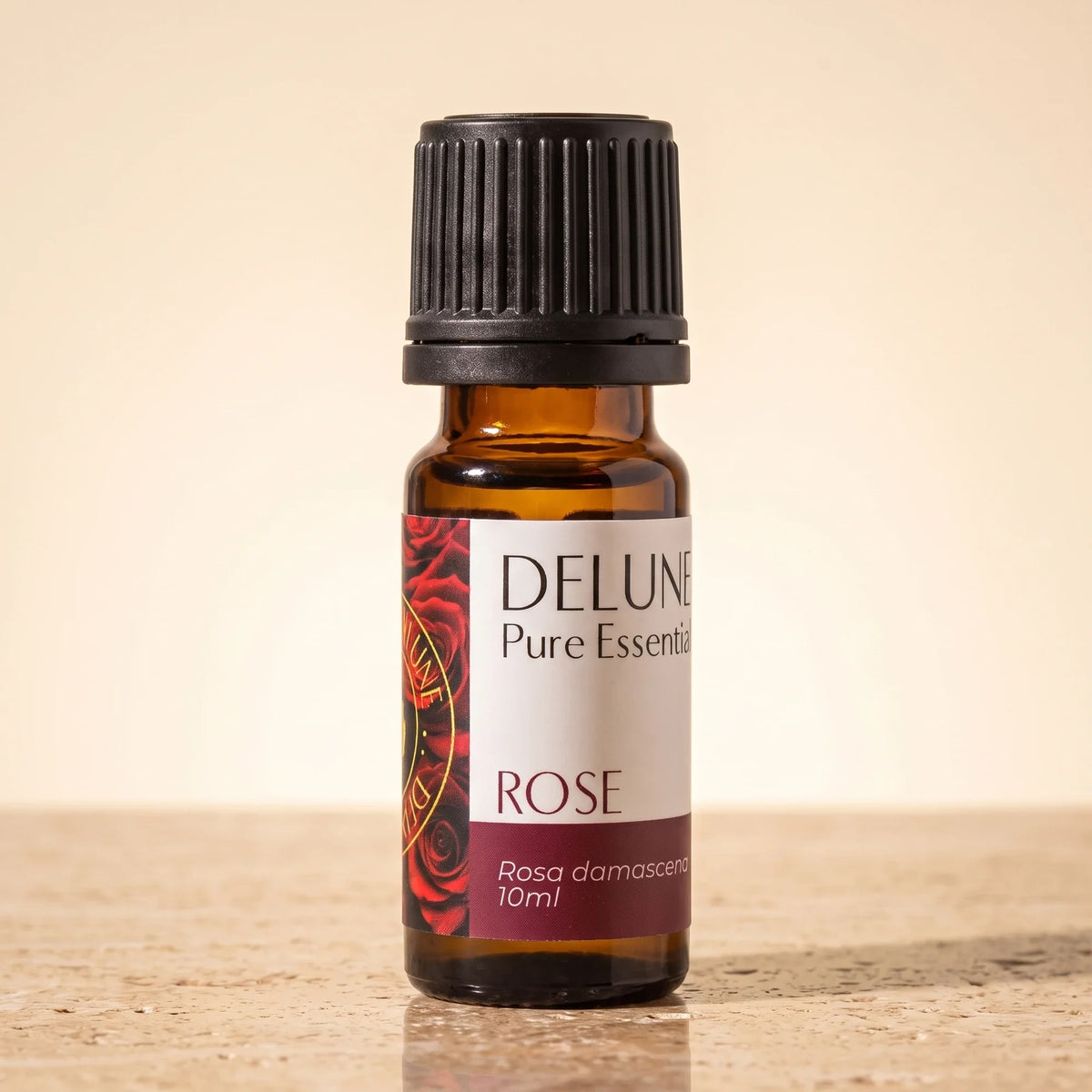Rose – ren æterisk olie fra Delune i 10 ml ravfarvet glasflaske på varm travertin